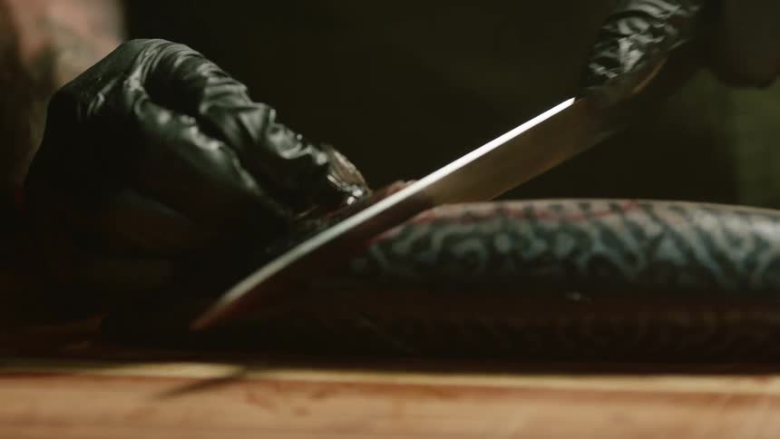 A person cutting up fish