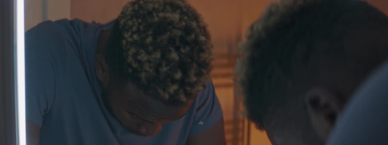 A man in a room looking at a mirror