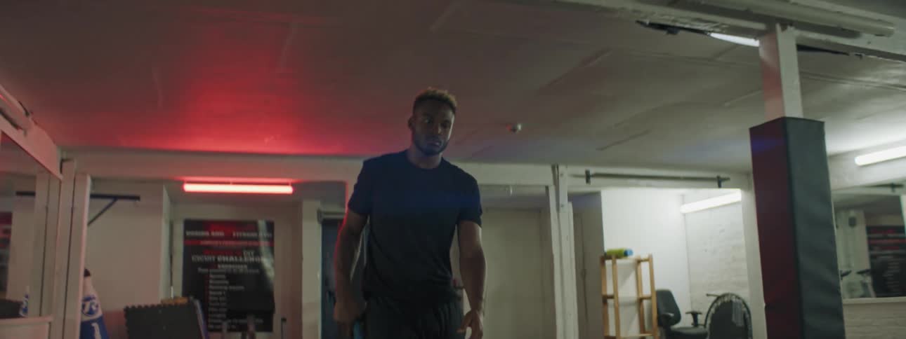 A man picks up ropes during his workout