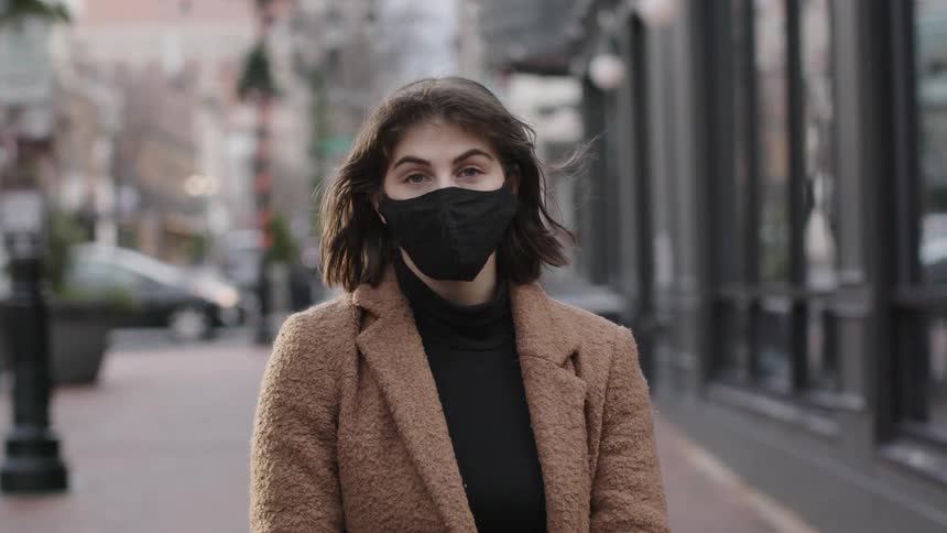 A woman with a mask standing
