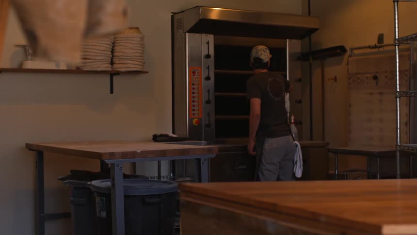 A worker cleans a kitchen