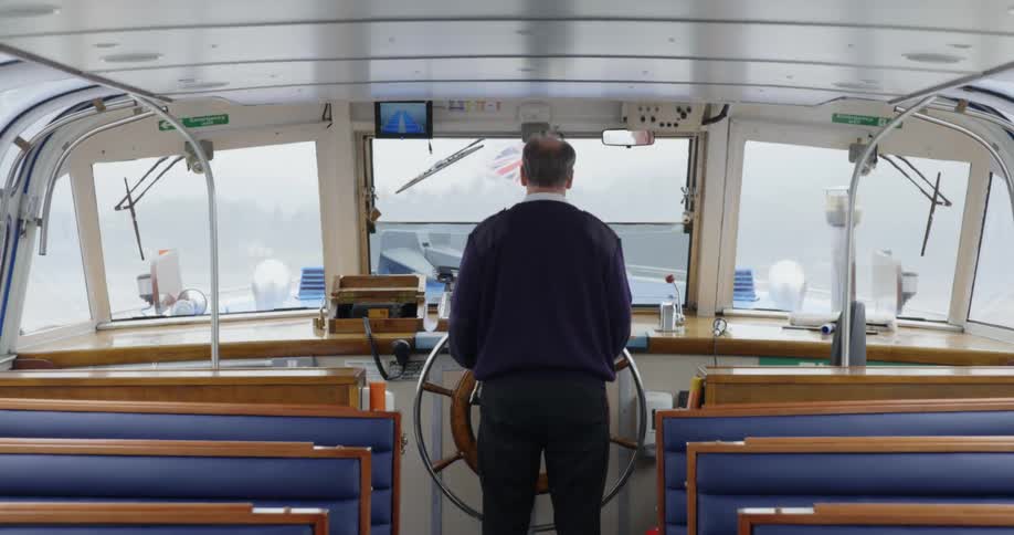 A man piloting a boat