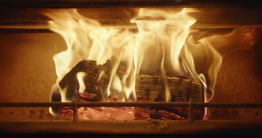 A fireplace with logs on fire