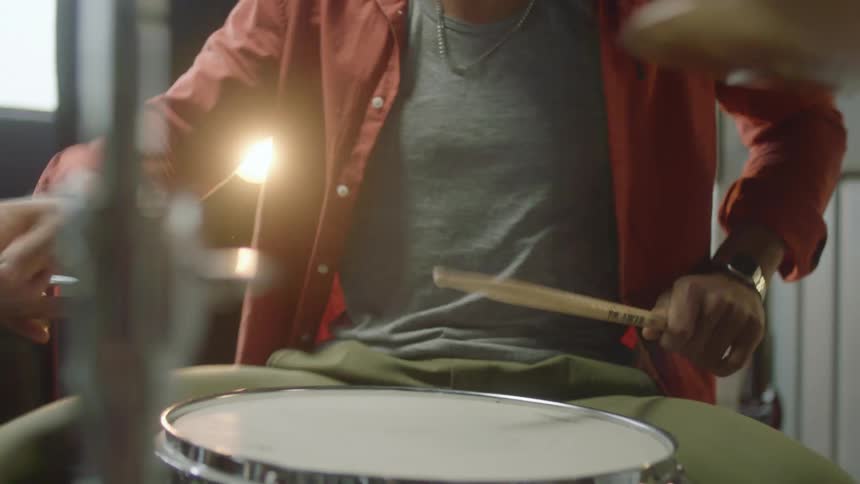 A person playing on a drum set