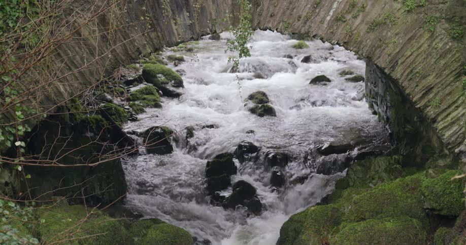 A stream under a stone bridge