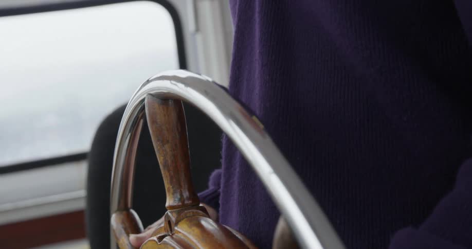 A captain steering a boat