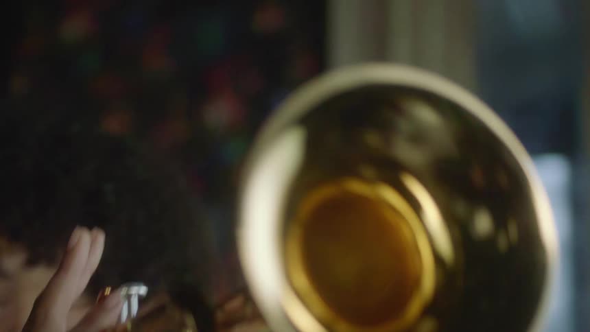 A person playing a trumpet in a room