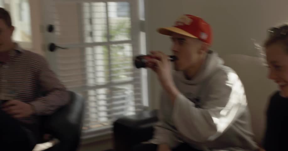 A group of people inside a house talking and laughing