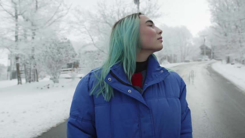 A woman standing out on a snowy road