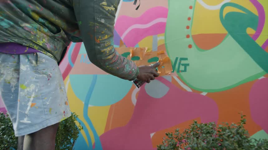 A man spray painting a wall