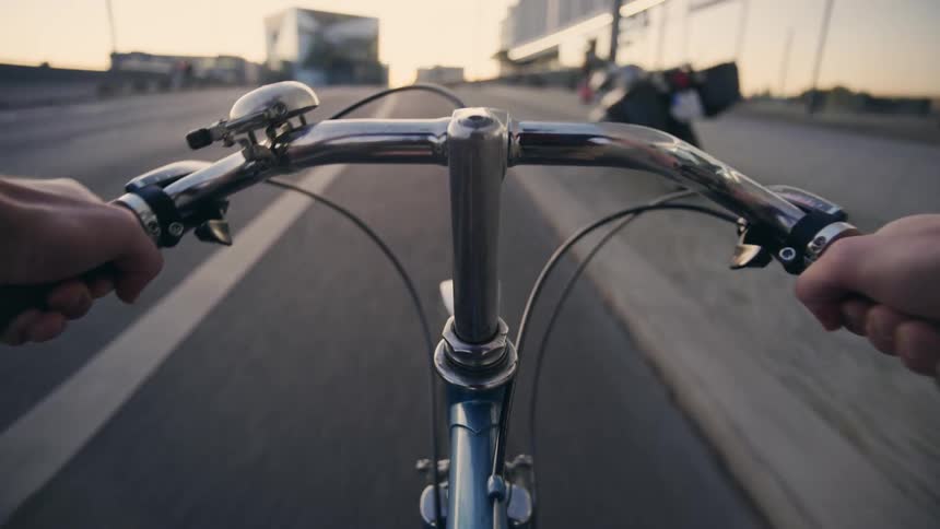 A person riding a bicycle on a road POV