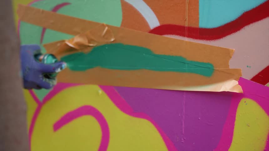 An artist spray painting
