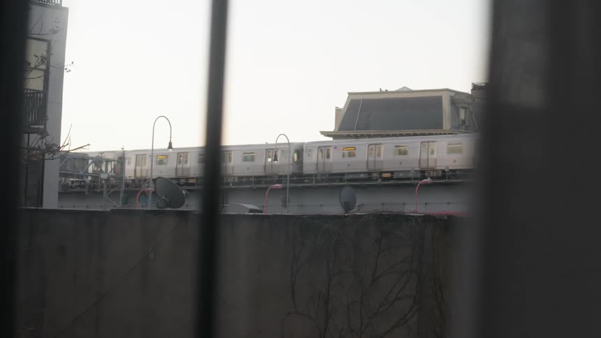 A train driving past buildings