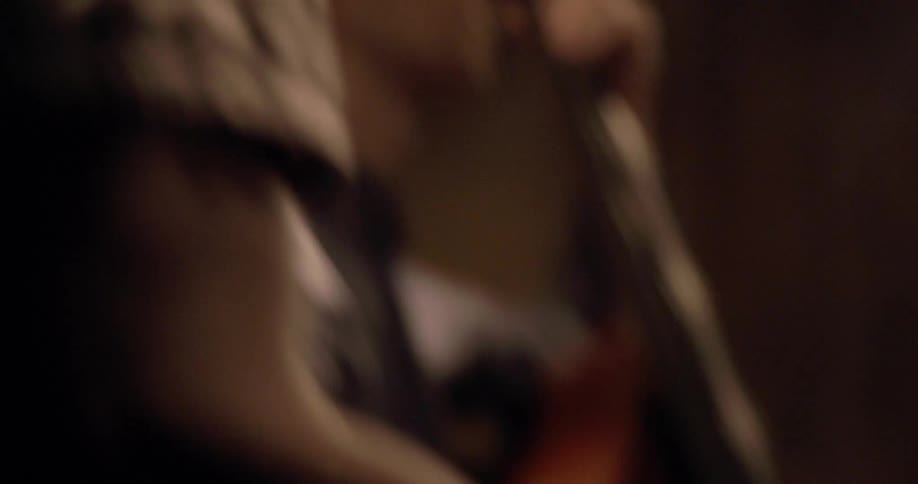 A man wearing glasses is playing drums