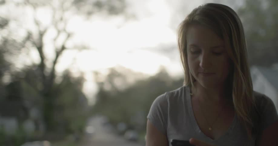 A phone is passed to a women who checks it