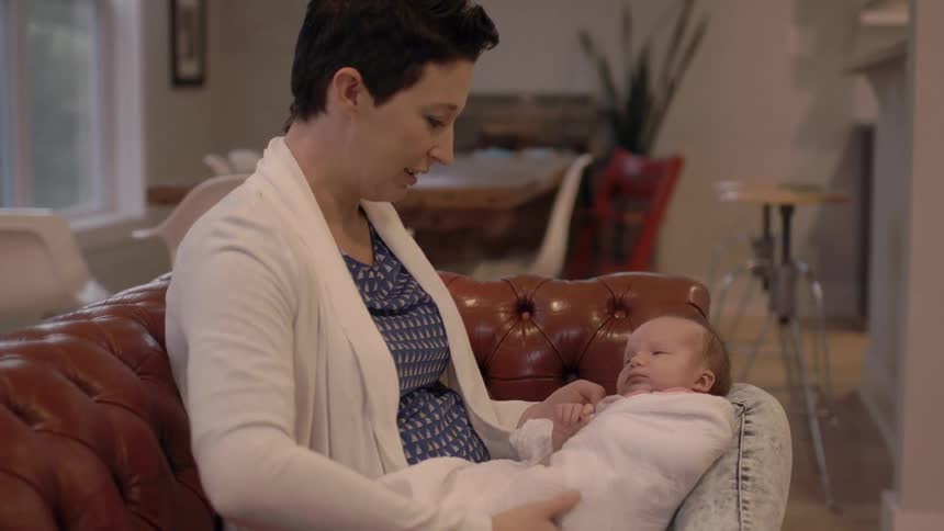 A woman swaddling a baby