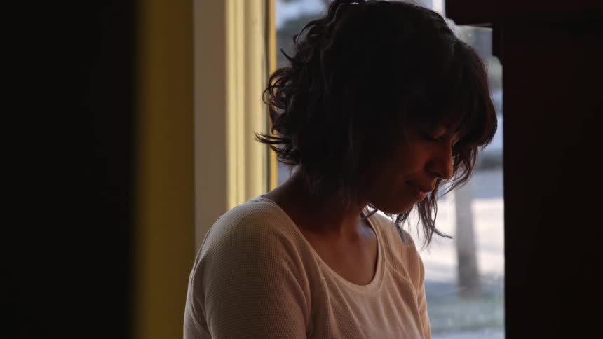 A woman sits alone inside