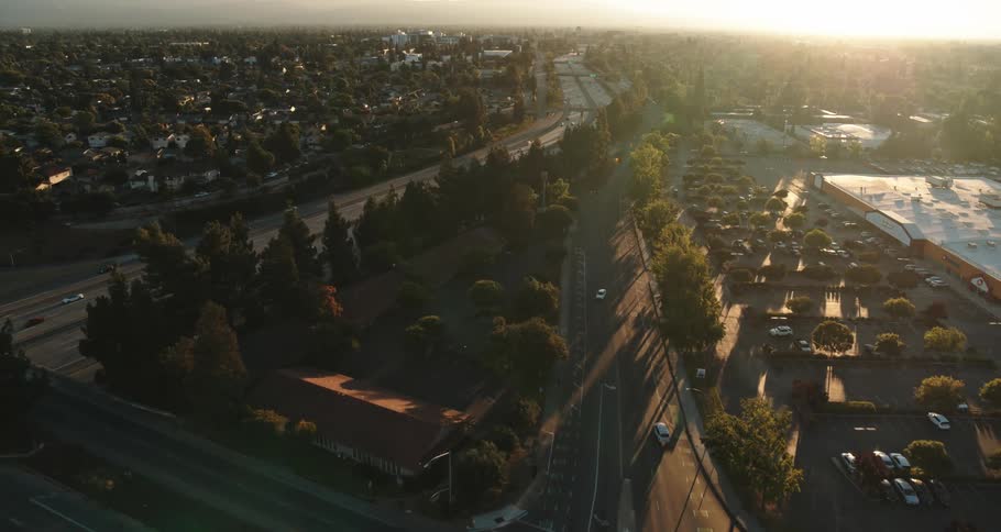 Flying over streets in a city looking at cars driving