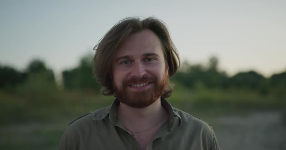 A man is standing outdoors in spring