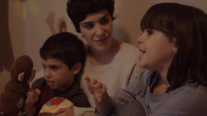 Children talk with their mother sitting