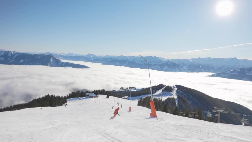 A wide shot of a mountain with a snowboarder