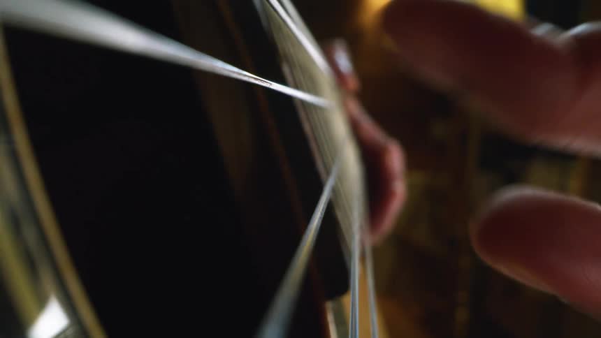 A close up of a person playing guitar