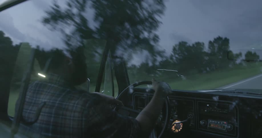 A man driving a truck down the road