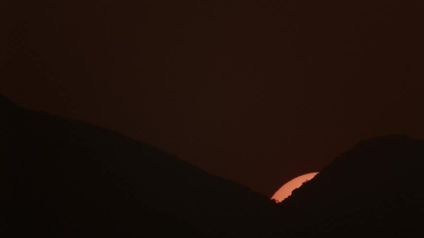 Sun is setting between two mountains