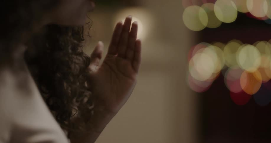 A woman gestures as she speaks passionately