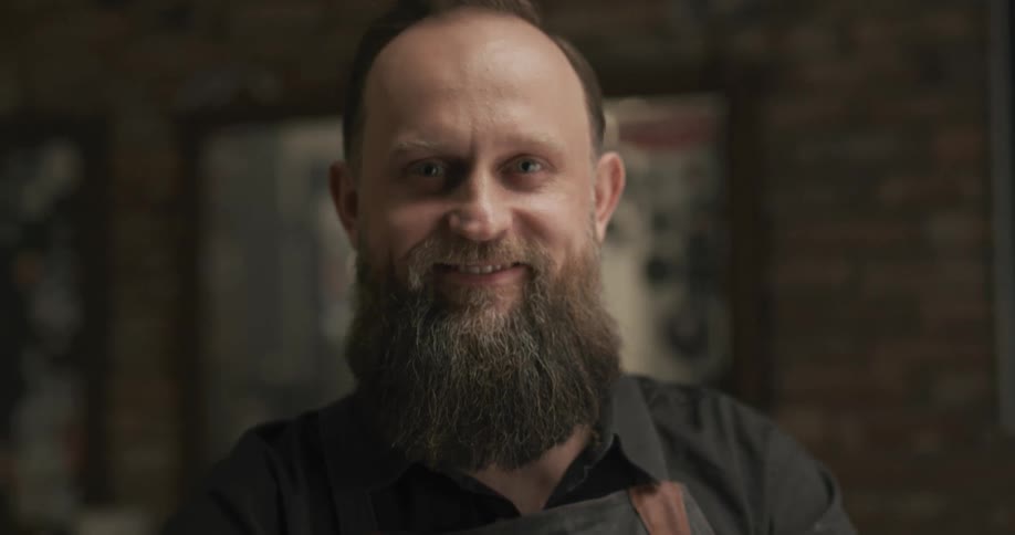 A man with a full beard smiles