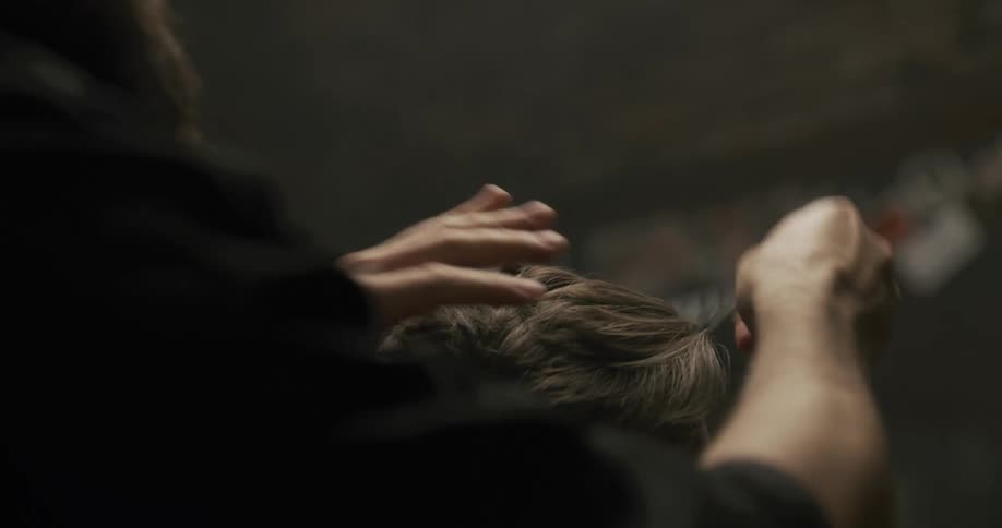 A barber combing a clients hair