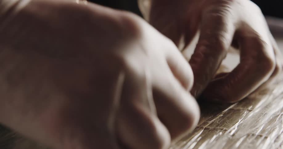 A chef is preparing some sushi