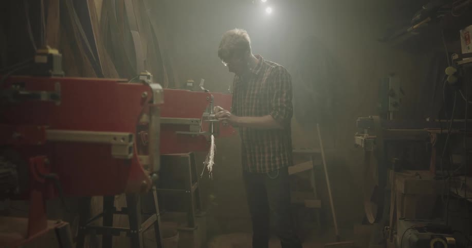 A man is sharpening a knife on the machine