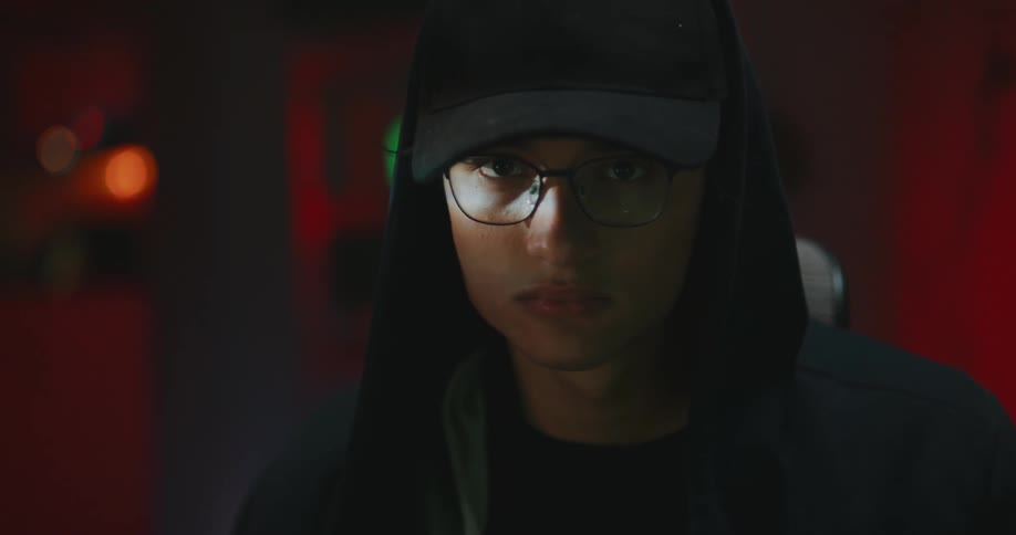A person is wearing a hat and glasses indoors