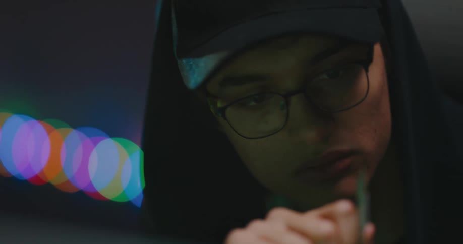A man is examining a computer chip