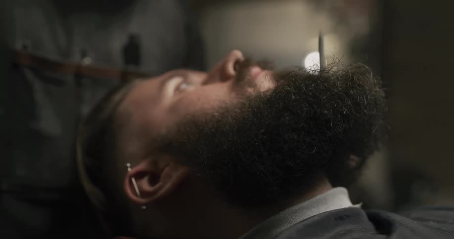 A man having his beard groomed