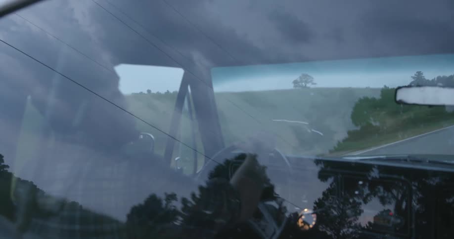 A man driving a vehicle down a road