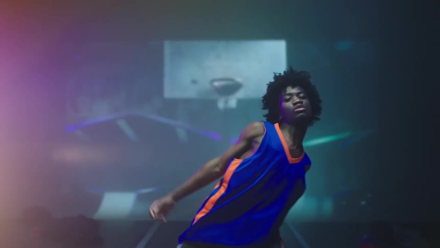 A man dancing in a studio in front of a screen