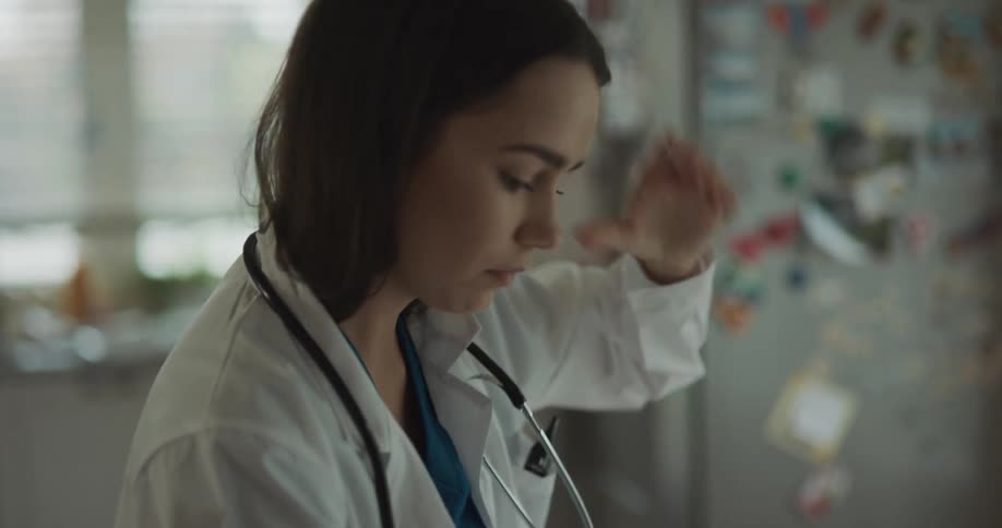 A nurse is getting ready for work indoors