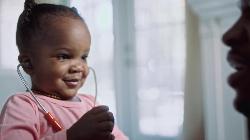 A girl is playing with a stethoscope