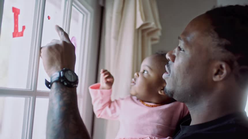 A man and child looking out a window