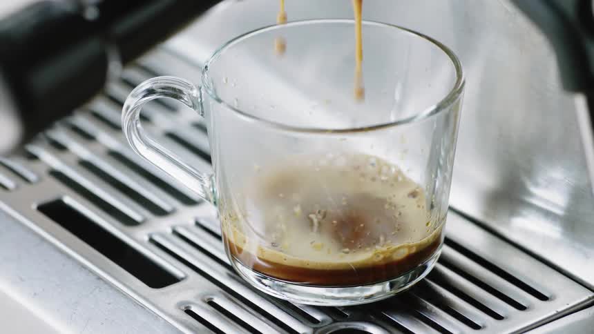 Espresso filling up a cup from an espresso machine