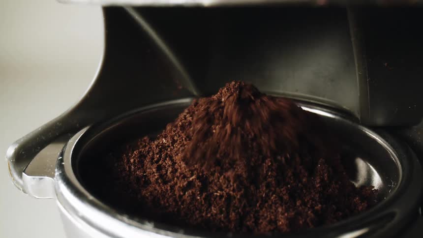 Coffee grounds falling into a cylinder