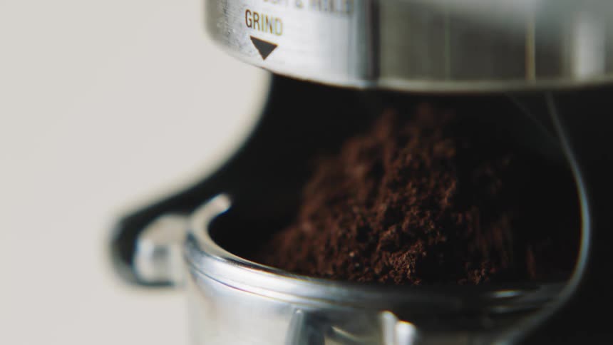 Coffee grounds falling into a cylinder
