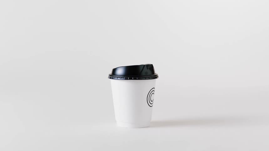 White cup with a circular design on the side and a black lid