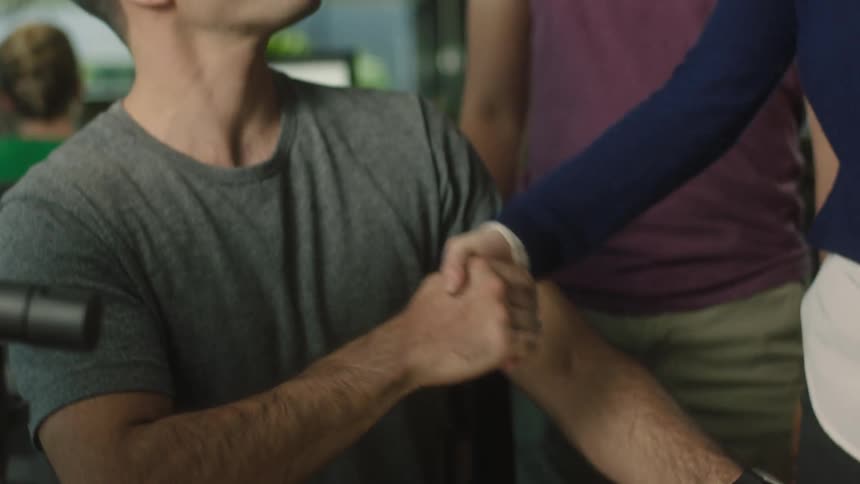 A man greeting other people in an office