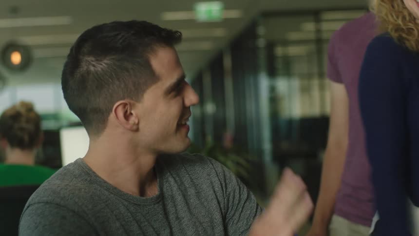 Three people talking together before two people leave
