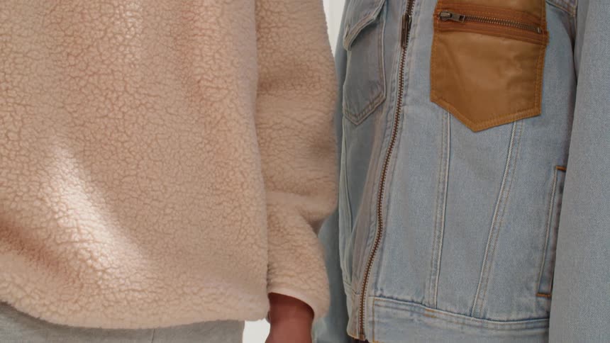 Two models pose with clothing on