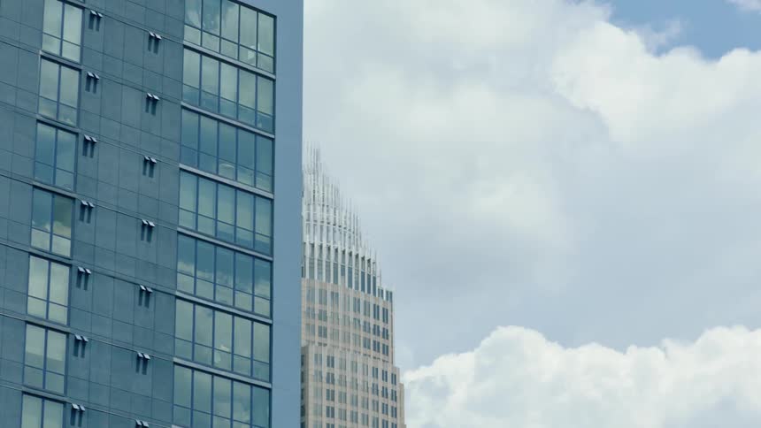 Tall buildings are displayed in a city on a cloudy day