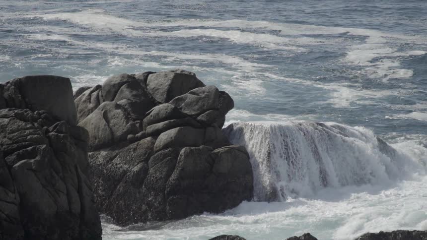 Water crashes onto a rock